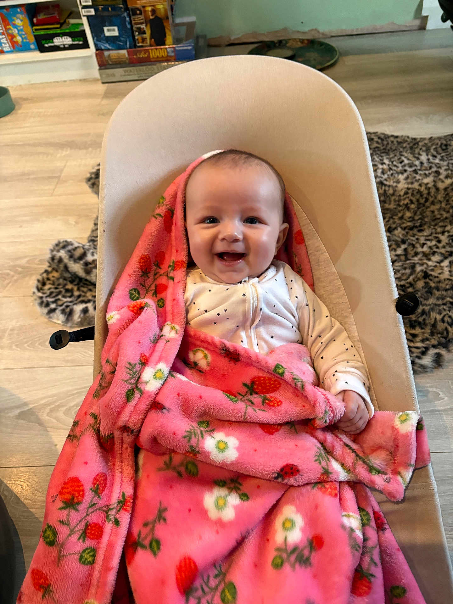Zaria joined the competition — help win amazing prizes! baby, blanket, pink, smiling, baby_seat, indoor, floor, wooden_floor, cozy, happy, child, face, infant, clothing, patterned_blanket, floral, home, comfort, sitting, cute
