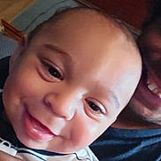 Corbin joined the competition — help win amazing prizes! baby, child, smile, face, striped_clothing, person, holding, adult, indoor, closeup, happy, skin, head, mouth, eyes, hand, portrait, infant, family, candid