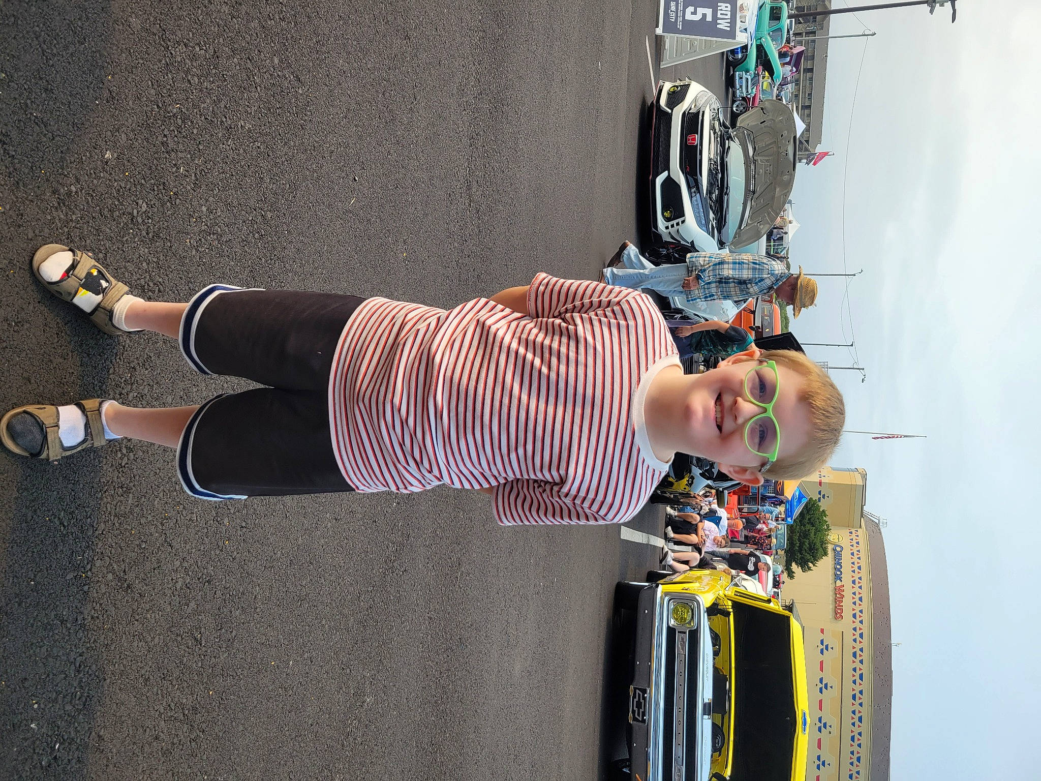 Landyn is registered to the contest to win money with this photo: bicycle_wheel, car, drum, entertainment, eyewear, fun, hat, headwear, helmet, human_leg, joy, knee, person, recreation, sandal, sunglasses, thigh, tire, tree, vehicle