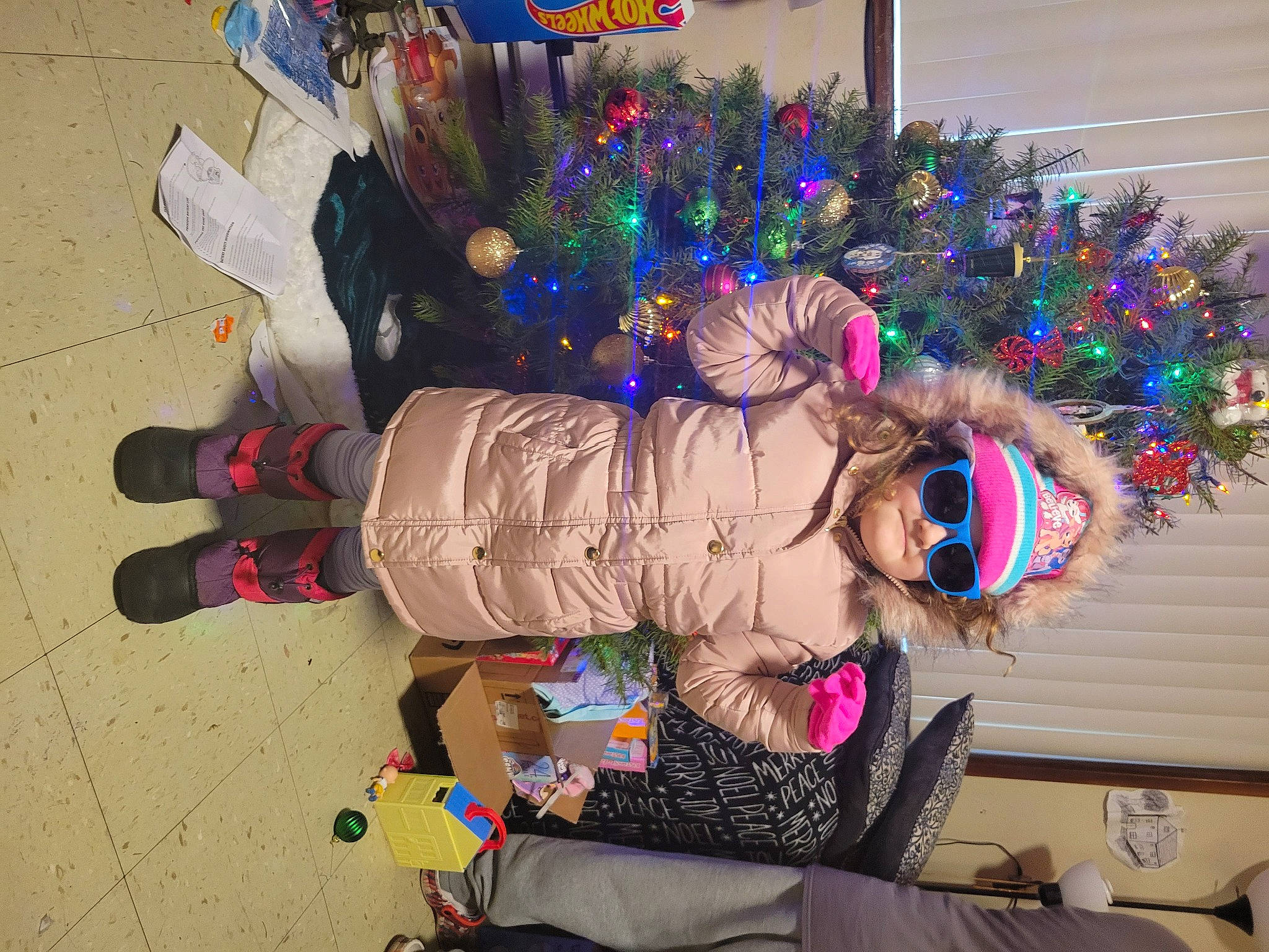 Madalynn is registered to the contest to win money with this photo: christmas, christmas_decoration, christmas_eve, christmas_ornament, christmas_tree, conifer, costume, costume_hat, event, fir, fun, fur, headwear, holiday, holiday_ornament, interior_design, ornament, person, purple, toddler