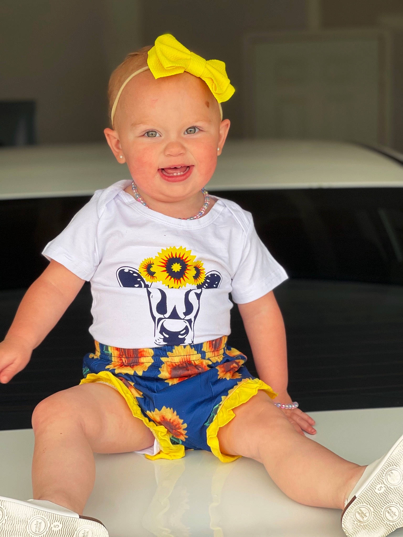 Paisley joined the competition — help win amazing prizes! baby, baby_toddler_clothing, cap, cheek, child, fun, happy, head, human_leg, joy, knee, person, shorts, sitting, skin, sleeve, smile, t_shirt, thigh, toddler