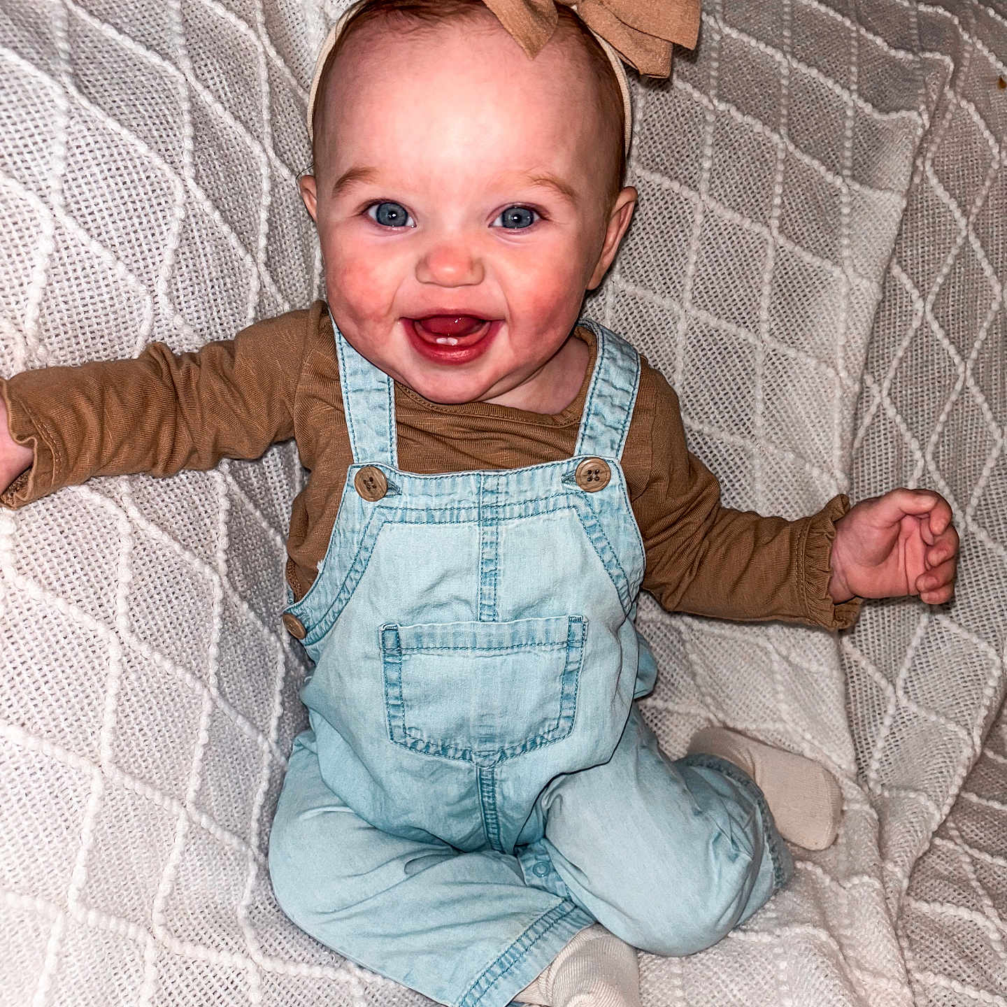 Palmer Jae is registered to the contest to win money with this photo: baby, babylaughing, bed, clothing, face, footwear, furniture, happy, head, hosiery, jeans, laughing, pants, person, photography, portrait, shoe, sitting, smile, sock