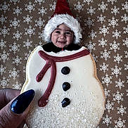 Enzo joined the competition — help win amazing prizes! baby, background, celebration, child, christmas, cookie, cute, face, festive, food, hand, holiday, icing, nail_polish, santa_hat, smile, snowflake_pattern, snowman, sweet, winter