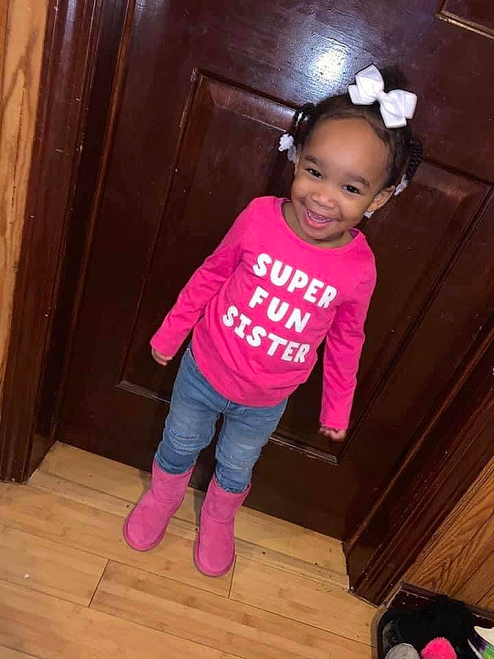 Shaniyah is registered to the contest to win money with this photo: baby_toddler_clothing, black, cheek, child, clothing, flash_photography, flooring, fun, happy, hardwood, joy, magenta, material_property, outerwear, person, pink, sleeve, t_shirt, toddler, varnish