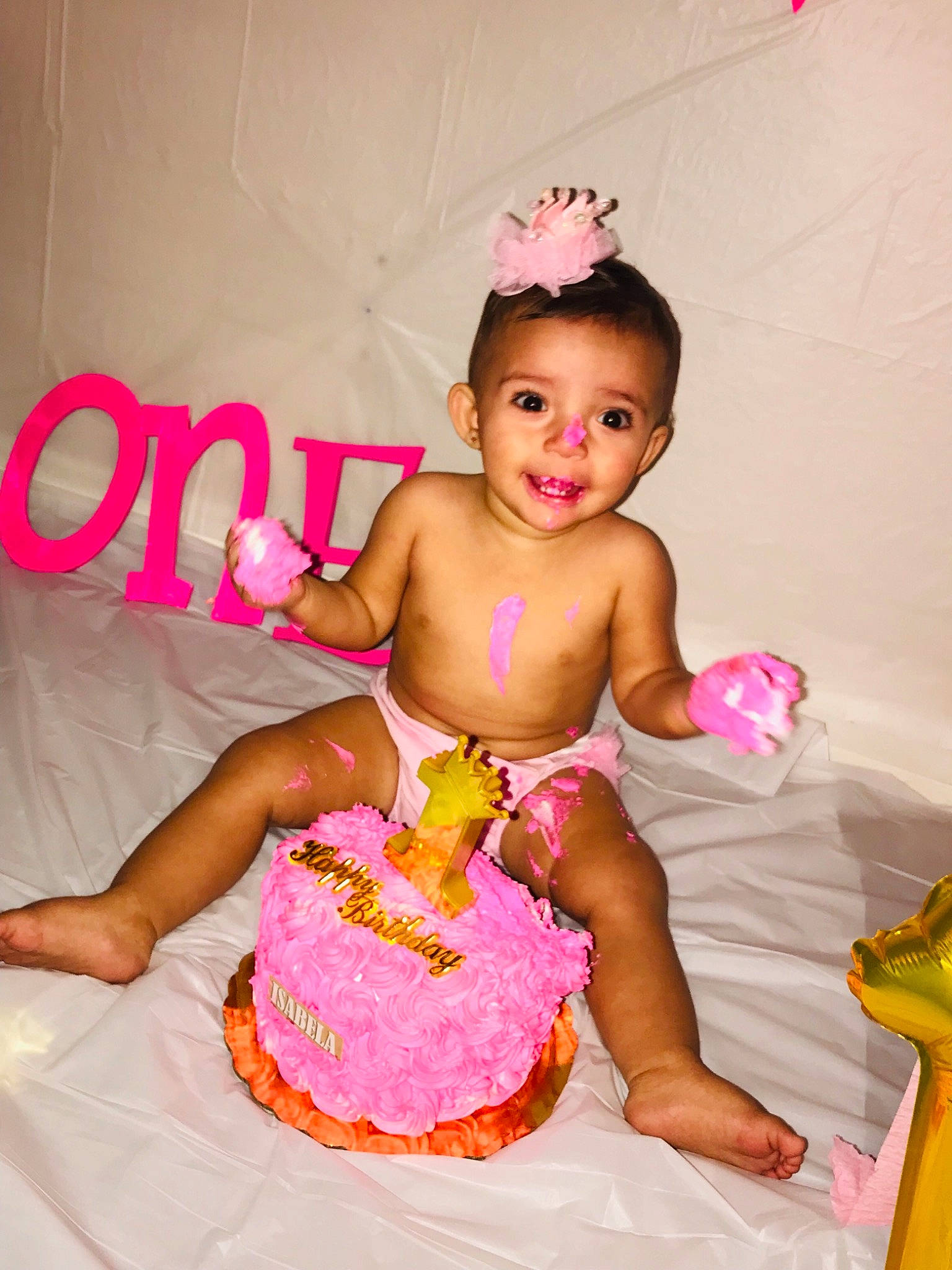 Isabella is registered to the contest to win money with this photo: baby, baby_bloomers, baby_products, baby_toddler_clothing, baked_goods, birthday, birthday_cake, cake, child, costume, dessert, food, hair_accessory, icing, joy, party, person, pink, sweetness, toddler