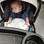 Lucas is registered to the contest to win money with this photo: baby, blanket, blue_clothing, car_seat, child, face, floor, hand, head, indoor, infant, peaceful, product_shelves, retail, seatbelt, shopping, sleeping, store, stroller, tile_floor
