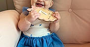 Amelia is registered to the contest to win money with this photo: baby, blue_skirt, child, clothing, cute, face, foot, hand, happy, headband, indoors, infant, milestone, one_month, person, plush_chair, portrait, sitting, skin, smiling