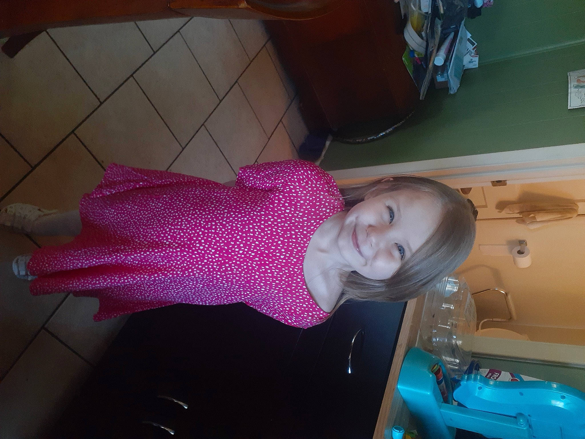 Karly joined the competition — help win amazing prizes! craft, creative_arts, fashion_accessory, flooring, fun, hat, human_leg, joy, magenta, pattern, person, room, smile, thread, vehicle_door, weaving, wool, woolen, woven_fabric