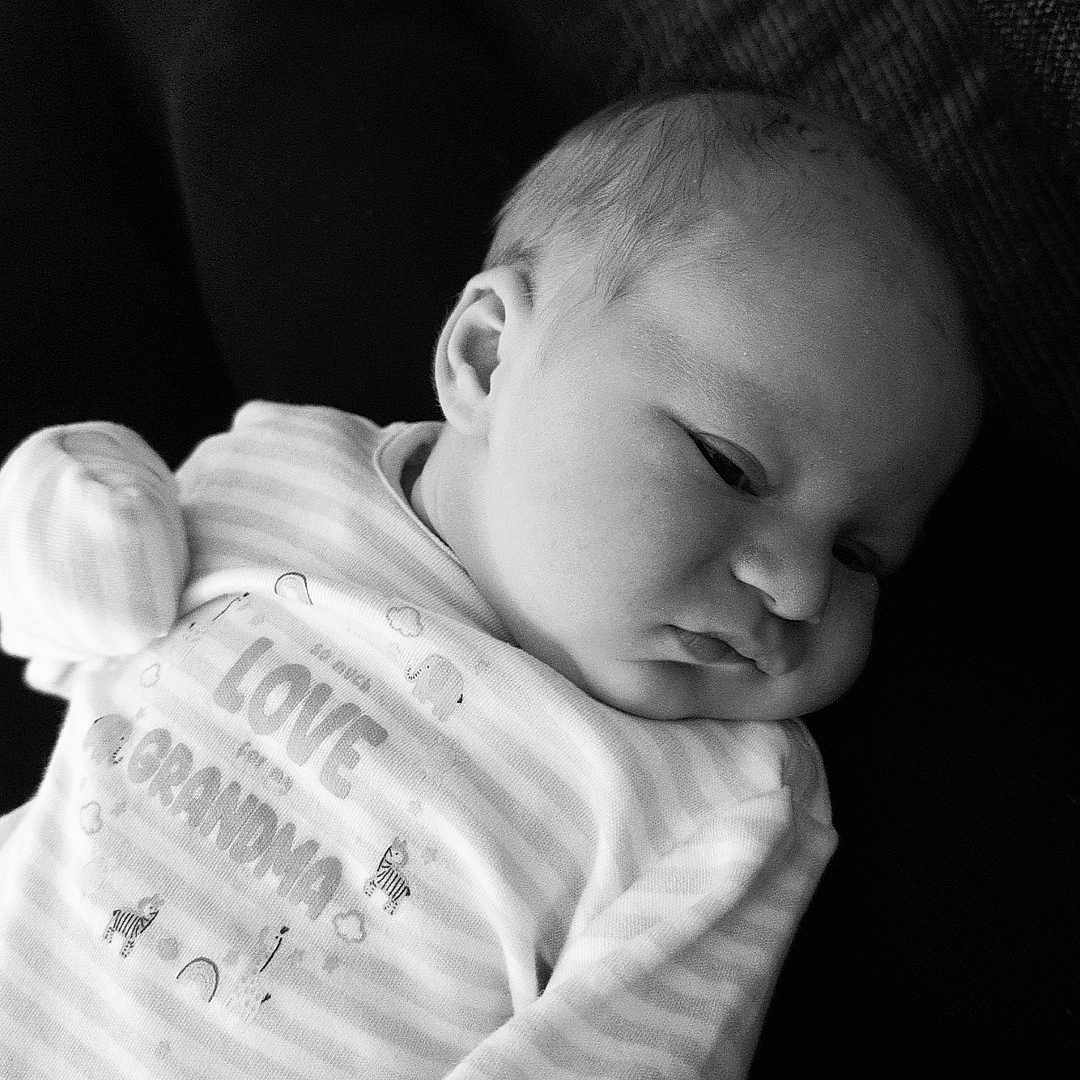 Liam-James joined the competition — help win amazing prizes! baby, black_and_white, closeup, comfort, couch, ear, face, hand, head, infant, lap, monochrome, newborn, pajamas, person, portrait, relaxing, sleepy, soft, striped_clothing