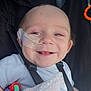 Bayley is registered to the contest to win money with this photo: baby, smile, nasal_tube, medical_tape, blanket, stroller, child, face, eyes, clothing, happy, infant, closeup, person, head, healthcare, cute, baby_toy, straps, indoors