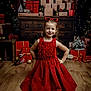 Candice a rejoint le concours — aidez-le/la à gagner de superbes lots ! child, girl, red_dress, heart_shaped_sunglasses, smiling, holiday, christmas, gifts, wrapped_presents, wooden_floor, decorations, festive, happy, posing, indoor, smile, young, celebration, joy, cute