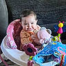 baby, child, infant, smiling, sitting, activity_center, jumper, toy, plush_elephant, butterfly_toy, colorful, indoor, living_room, couch, blanket, playtime, portrait, face, happy, baby_clothing