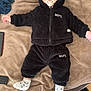 Ilyess participe au concours pour gagner de l'argent avec cette photo : baby, bedroom, black_clothing, blanket, casual, child, cozy, cute, expressionless, floor, hoodie, indoors, infant, lying_down, pacifier, pants, person, slippers, socks, soft_texture