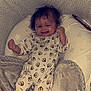 baby, blanket, child, cozy, cushion, cute, face, foot, hair, hand, happy, indoor, infant, lying_down, monkey_pattern, onesie, pacifier, sleeping_area, smiling, soft_texture