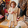 Kataleya is registered to the contest to win money with this photo: child, toddler, curly_hair, white_dress, indoor, carpet, leopard_print, jacket, flowers, mirror, wooden_floor, toy, socks, furniture, spray_bottle, clothing, household_items, person, standing, cute