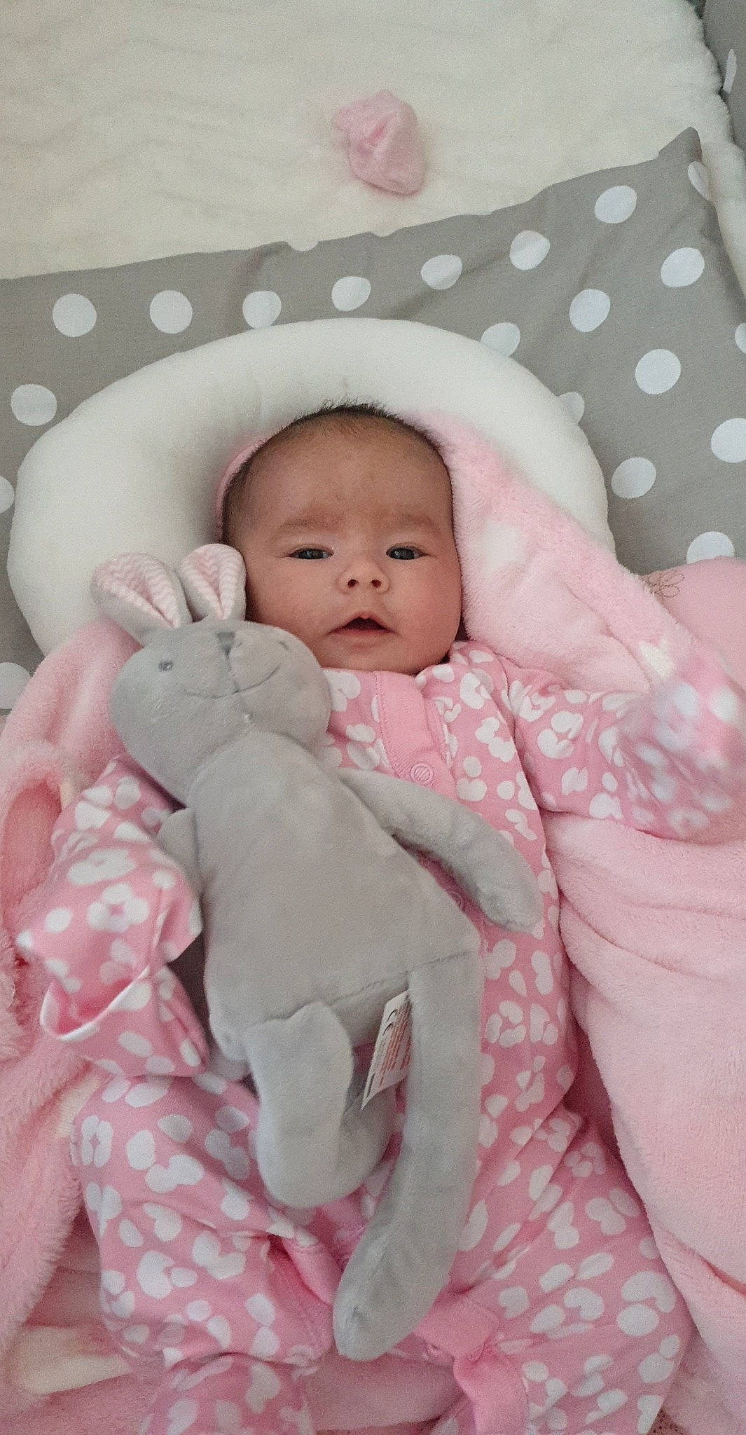 Ellie-mae is registered to the contest to win money with this photo: baby, baby_products, bedding, bedtime, blanket, cheek, child, face, head, linens, person, pink, product, skin, textile, toddler