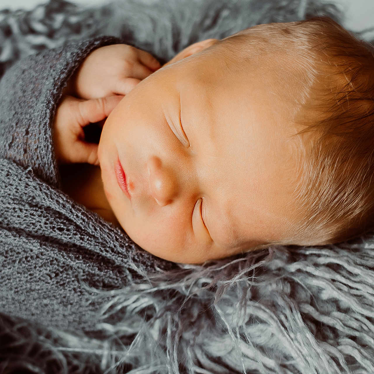 Titus joined the competition — help win amazing prizes! baby, blanket, clothing, face, happy, head, hoodie, knitwear, newborn, person, photography, portrait, sleeping, smile, sweater, sweatshirt