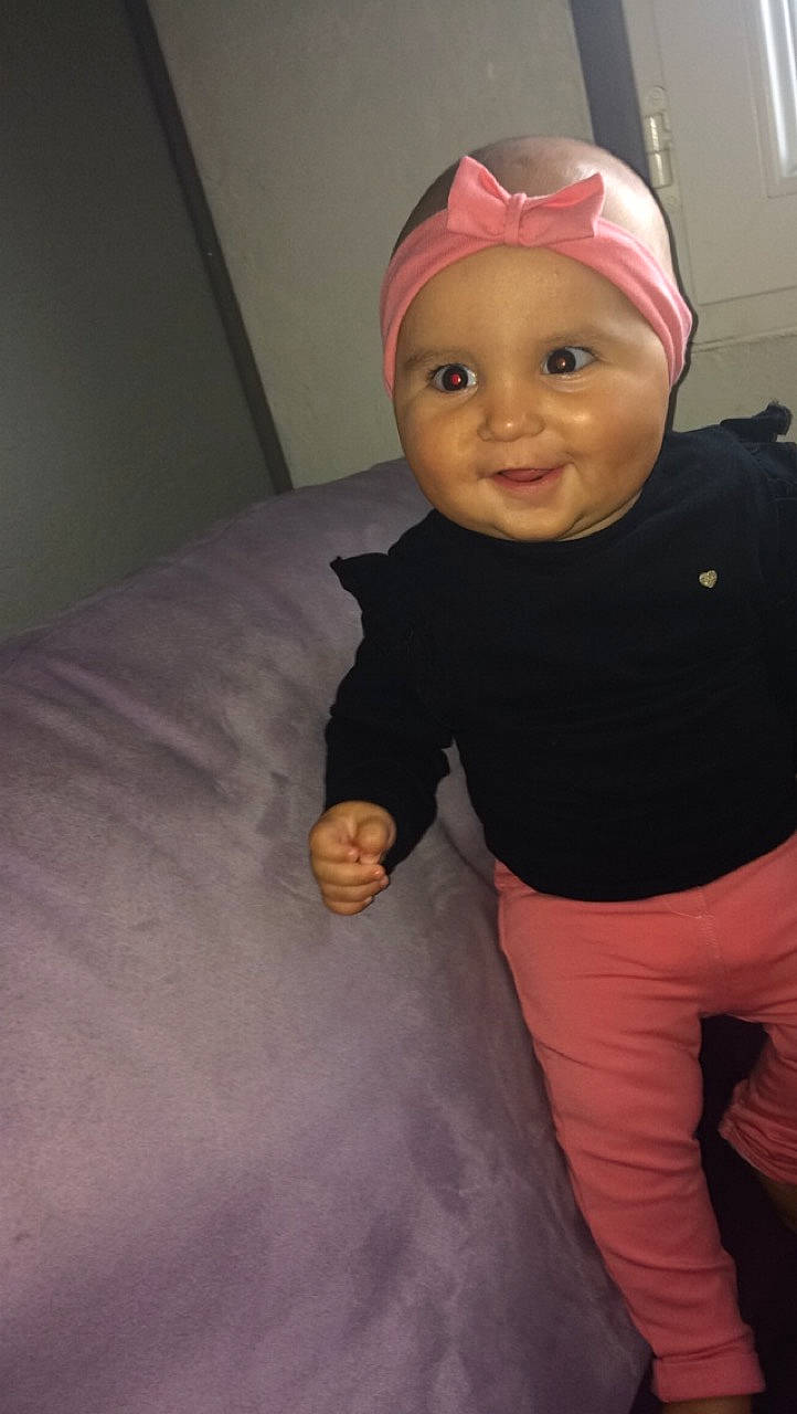 Katalina participe au concours pour gagner de l'argent avec cette photo : baby, cheek, child, fun, hair_accessory, headgear, person, pink, skin, smile, toddler