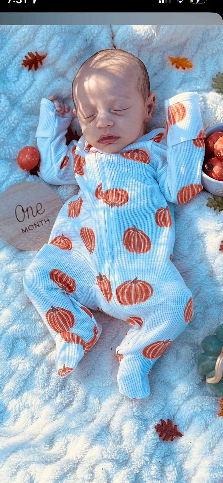 Waylon is registered to the contest to win money with this photo: baby, infant, sleeping, onesie, pumpkin_pattern, blanket, autumn_leaves, decorations, soft_light, shadow, face, hand, footed_pajamas, cuteness, peaceful, newborn, seasonal, cozy, closeup, portrait