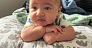 Xavier joined the competition — help win amazing prizes! arms, baby, blanket, child, clothing, comfort, curious, cute, elephant_pattern, expression, face, head_support, indoor, infant, person, pillow, resting, skin, soft, young