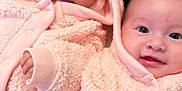 Daleyza is registered to the contest to win money with this photo: baby, infant, pink_clothing, hooded_jacket, twin, cute, smile, lying_down, soft_texture, warm, child, indoor, face, closeup, adorable, person, cozy, sleepwear, newborn, happy