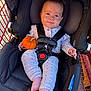 Daleyza joined the competition — help win amazing prizes! baby, car_seat, shopping_cart, pumpkin, clothing, polka_dot, infant, straps, black, orange, cute, child, seat_belt, pink_socks, expression, outdoor, daylight, face, person, baby_girl