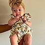 Jerzy is registered to the contest to win money with this photo: baby, child, infant, headband, bow, floral_outfit, hands, skin, indoor, wall, person, cute, expression, sitting, holding, human, small_child, portrait, clothing, adorable