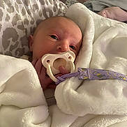 Brynleigh joined the competition — help win amazing prizes! baby, pacifier, blanket, bed, infant, purple, white, soft, cute, wrapped, cozy, newborn, sleeping, face, hand, bedroom, comfort, toddler, child, rest