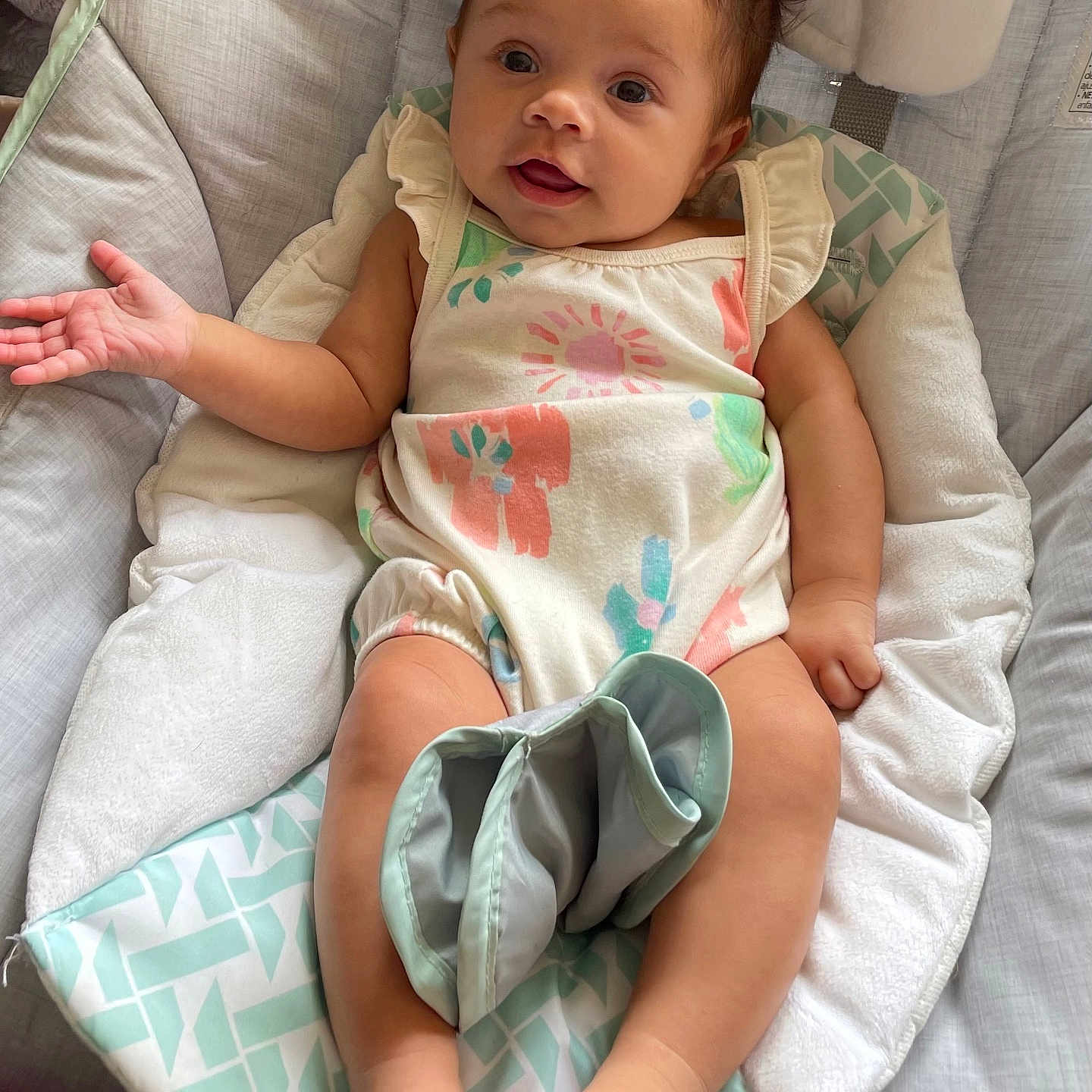 Ivanna joined the competition — help win amazing prizes! baby, infant, child, onesie, curly_hair, smiling, cushion, baby_seat, hand, foot, skin, expression, indoor, relaxing, clothing, person, portrait, cute, young, happy