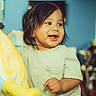 toddler, child, smiling, happy, indoor, playroom, toy, playground_ride, colorful, young_child, portrait, face, casual_clothing, short_sleeve_shirt, baby, cute, fun, joy, cheerful, hands