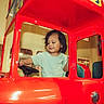 Jared joined the competition — help win amazing prizes! toddler, child, toy_vehicle, red, indoor, play_area, steering_wheel, curious, cute, childrens_play, fun, casual_clothing, short_hair, smiling, seat, window, colorful, entertainment, leisure, person