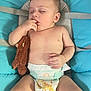 baby, blue_cushion, child, closeup, comfort, cute, diaper, face, hand, indoors, infant, nap, peaceful, person, plush_toy, rest, skin, sleeping, teddy_bear, toy