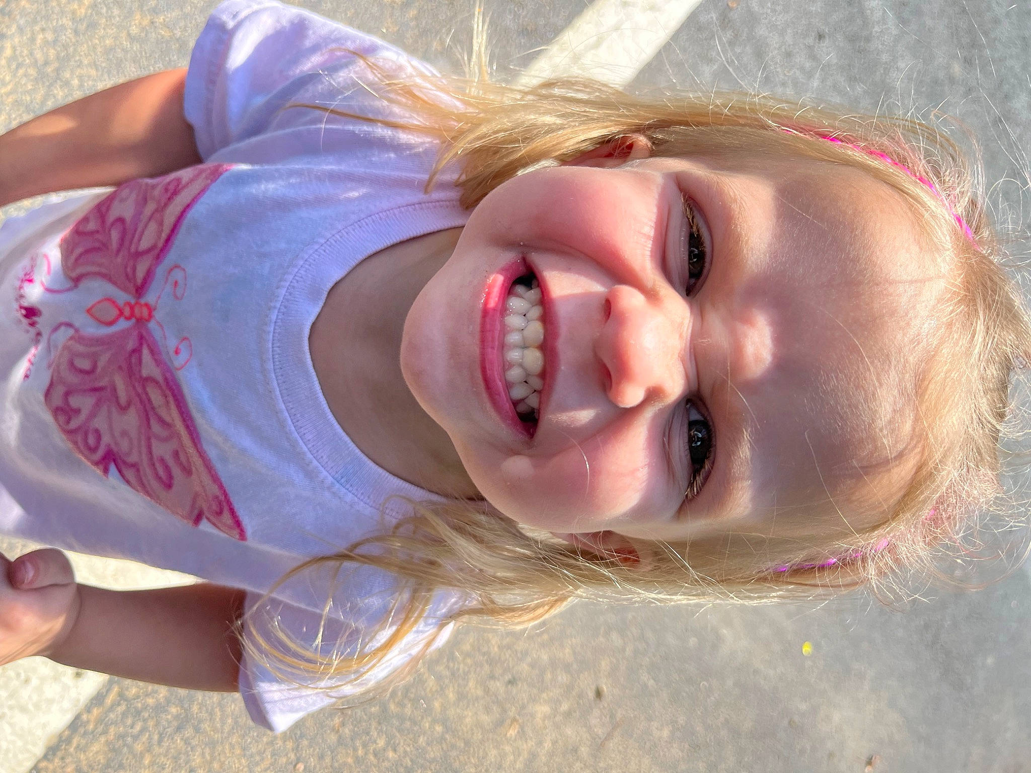 Mia Rose is registered to the contest to win money with this photo: blond, brown_hair, cheek, child, ear, eyelash, facial_expression, fun, grass, happy, jaw, joy, laugh, lip, long_hair, nose, person, skin, smile, toddler