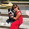 girl, dog, red_dress, steps, water_fountain, globe, outdoor, sunny, pet, child, leash, smiling, happy, candid, urban, casual, summer, playful, nature, park