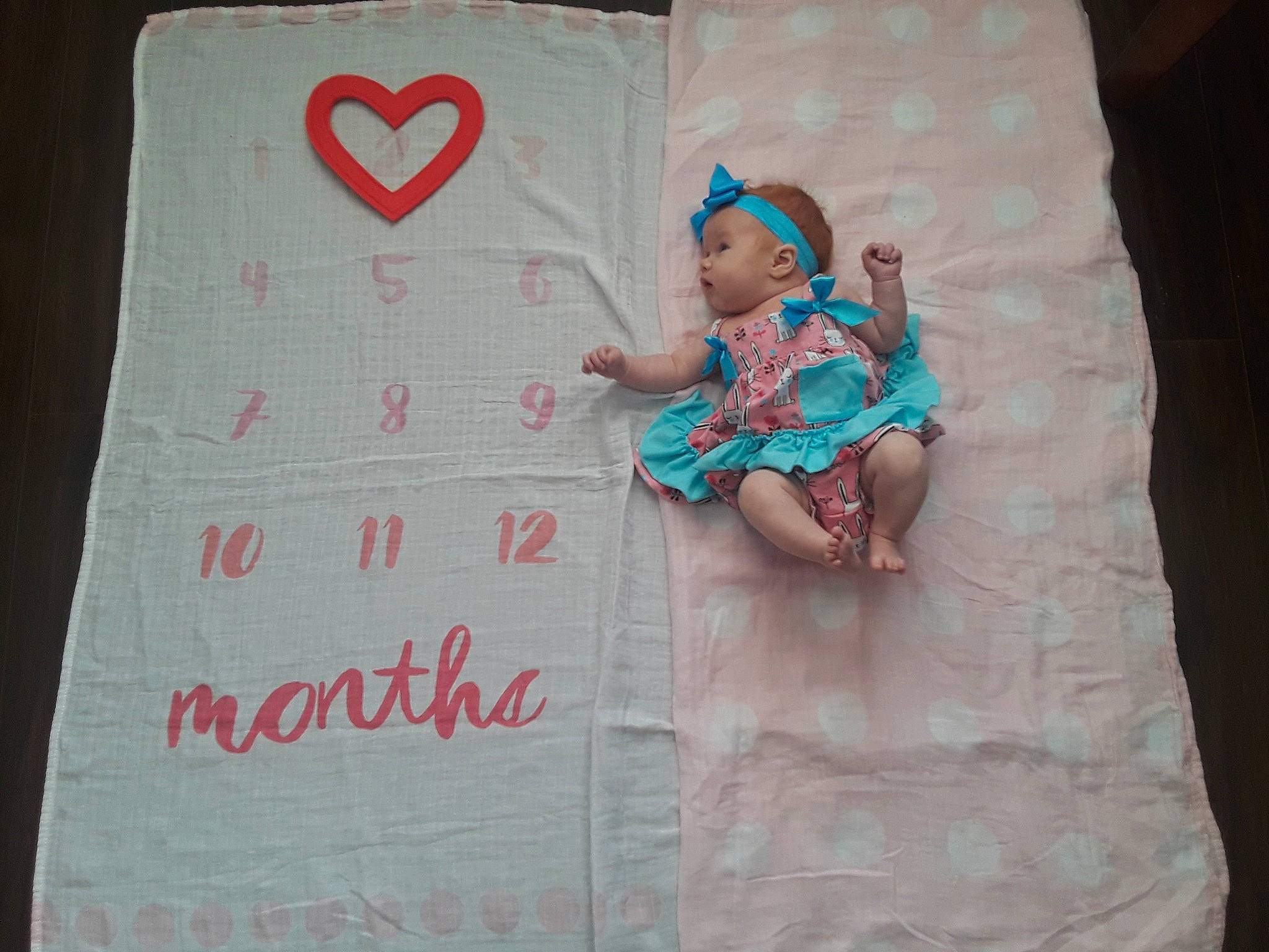 Emmersyn joined the competition — help win amazing prizes! baby, blanket, child, linens, nap_mat, pattern, person, pink, text, textile, turquoise