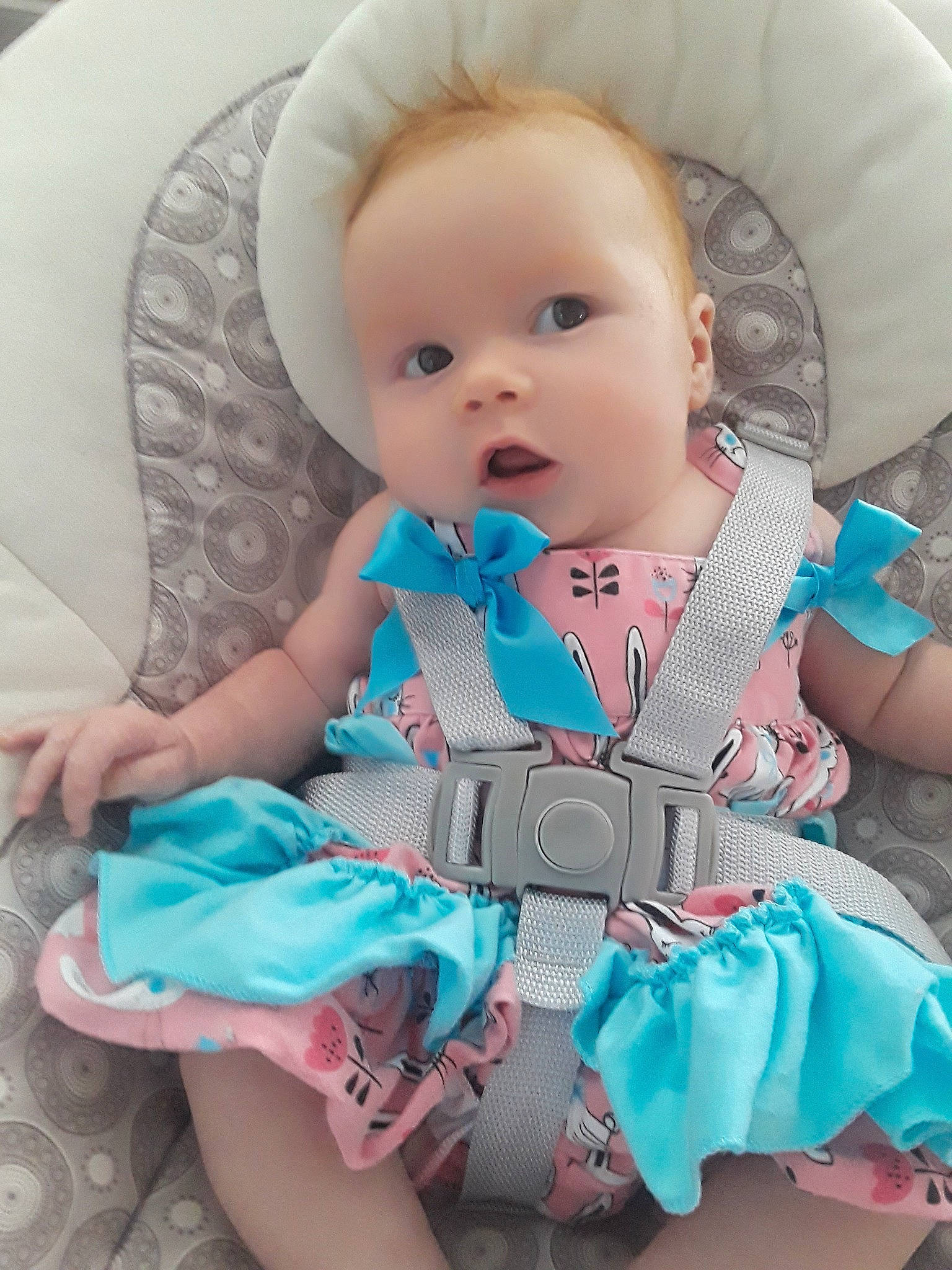 Emmersyn is registered to the contest to win money with this photo: baby, baby_products, baby_toddler_clothing, blue, cheek, child, dress, eye, head, iris, person, pink, product, sitting, skin, sleeve, toddler, turquoise