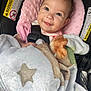 Chloe is registered to the contest to win money with this photo: baby, child, car_seat, blanket, pink, smile, happy, face, infant, cute, cozy, safety_harness, soft_texture, star_pattern, clothing, indoor, portrait, person, head, eyes