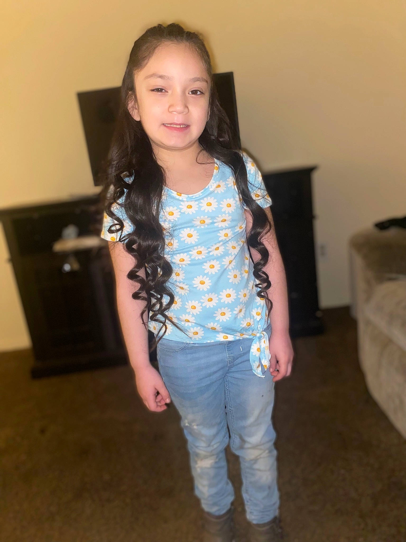 Aviona is registered to the contest to win money with this photo: denim, electric_blue, face, fashion_design, fun, happy, human_leg, jewellery, joy, knee, long_hair, pattern, person, shoulder, sleeve, smile, standing, t_shirt, thigh, toddler