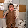 Lewis participe au concours pour gagner de l'argent avec cette photo : baby, child, infant, smiling, overalls, striped_shirt, patchwork_quilt, stars, deer, woodland_animals, lying_down, happy, soft_texture, brown, beige, cute, cozy, indoors, playmat, baby_socks