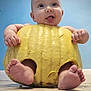 baby, blue_wall, child, chubby, cute, face, feet, floor, funny, hands, hollow, indoors, infant, person, playful, pumpkin, skin, smile, tongue, yellow