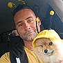 man, dog, costume, bee_costume, yellow, black, antennae, pet, fluffy_dog, puppy, car_interior, portrait, smile, cute, animal, human, friendship, indoors, fun, matching_outfits