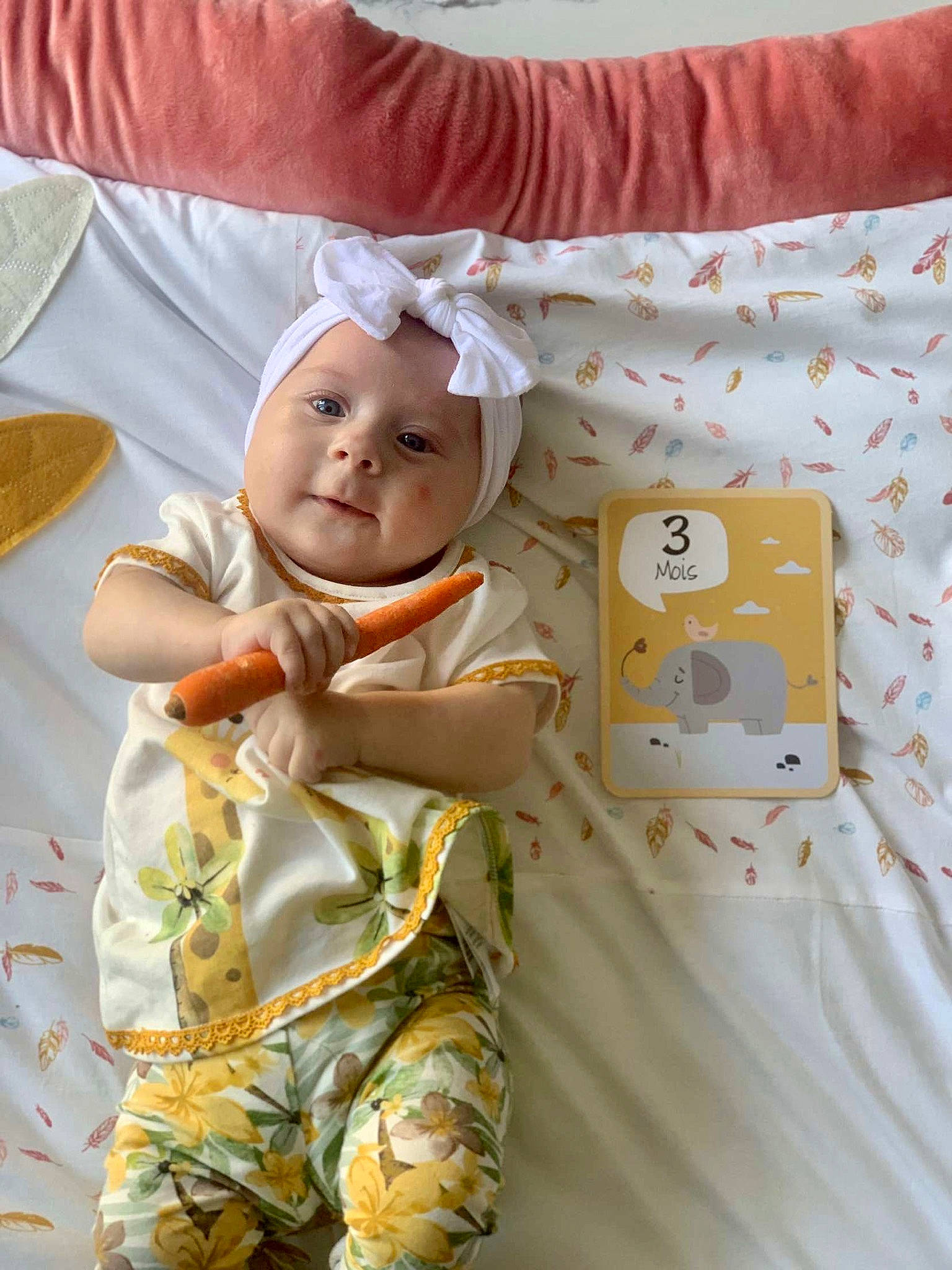 Mya participe au concours pour gagner de l'argent avec cette photo : baby, baby_products, baby_safety, baby_toddler_clothing, bed_sheet, bedding, child, comfort, happy, headwear, linens, pattern, peach, person, product, room, skin, sleeve, smile, textile