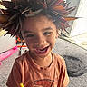 Seilose Brianna joined the competition — help win amazing prizes! child, smiling, leaf_crown, orange_shirt, indoor, carpet, toy_scooter, pen, happy, face, person, short_hair, playful, home, casual_clothing, expression, cute, young, creative, fun