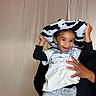 Seilose Brianna joined the competition — help win amazing prizes! child, toddler, smiling, hat, cow_print, black_and_white, person, hands, clothing, jeans, white_shirt, long_sleeves, indoor, background, joyful, cute, portrait, happy, playful, fun