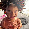 brown_leaves, carpet, casual_clothing, child, closeup, cute, daylight, fun, happy, headwear, indoor, leaf_crown, natural, person, playful, portrait, scooter, smiling, tshirt, young_child