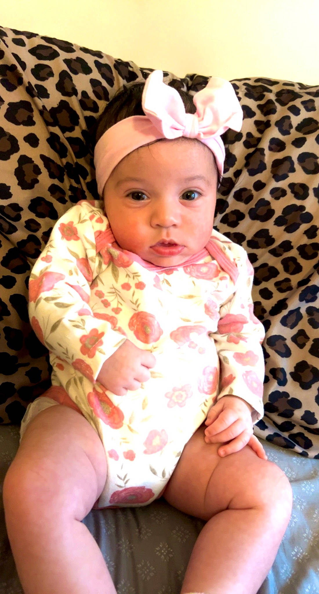 London is registered to the contest to win money with this photo: baby, baby_toddler_clothing, cheek, chest, child, chin, collar, comfort, eye, face, headwear, human_body, human_leg, lip, neck, pattern, person, pink, skin, sleeve