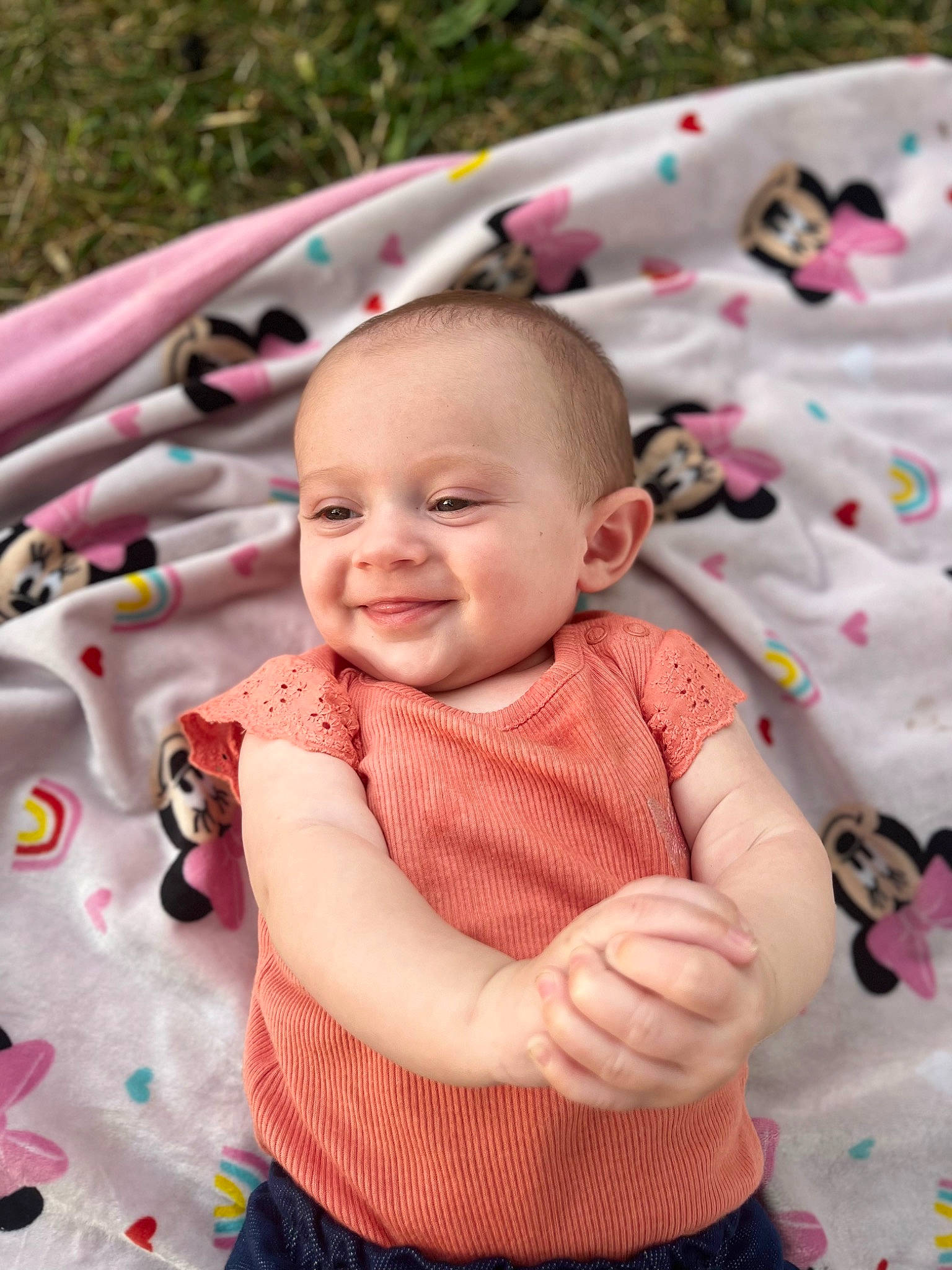 Esther is registered to the contest to win money with this photo: baby, baby_toddler_clothing, cheek, child, clothing, facial_expression, fun, grass, happy, iris, joy, leisure, person, photograph, pink, plant, product, skin, sleeve, smile