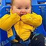 Liam joined the competition — help win amazing prizes! baby, blue_seat, buckle, chewing, child, clothing, cozy, cute, eyes, harness, indoor, legs, mittens, playful, portrait, puffer_jacket, shopping_cart, smiling, toddler, yellow_jacket