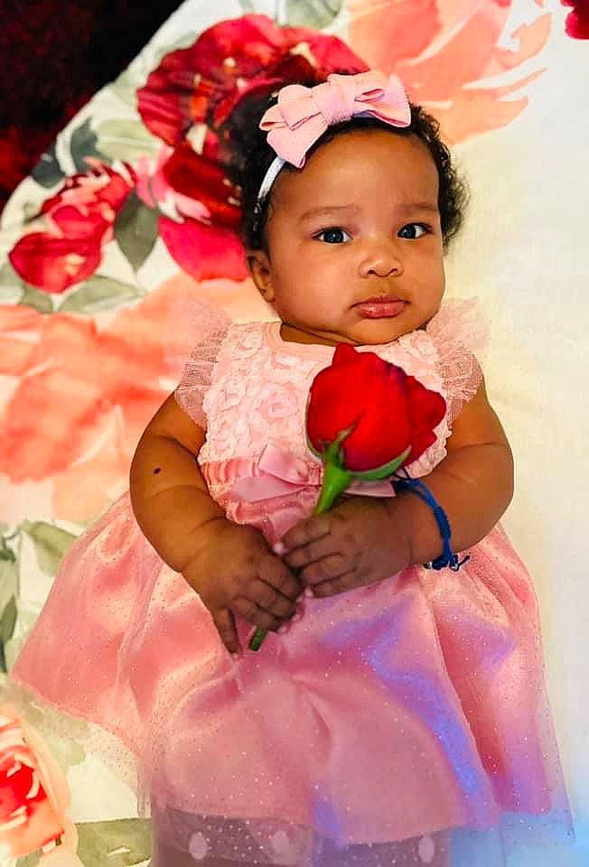 Aya joined the competition — help win amazing prizes! arm, baby, baby_toddler_clothing, dress, eye, finger, flower, hand, happy, head, headgear, headpiece, human_body, person, petal, pink, plant, red, rose, skin