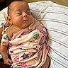 Sarah is registered to the contest to win money with this photo: baby, infant, sleeping, hospital, blanket, swaddle, portrait, face, closed_eyes, peaceful, medical_equipment, iv_line, hospital_bed, striped_sheet, pink_clothing, colorful_blanket, indoor, resting, newborn, care
